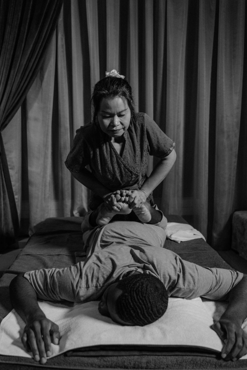 Professional masseur performs a therapeutic massage in a relaxing spa setting.